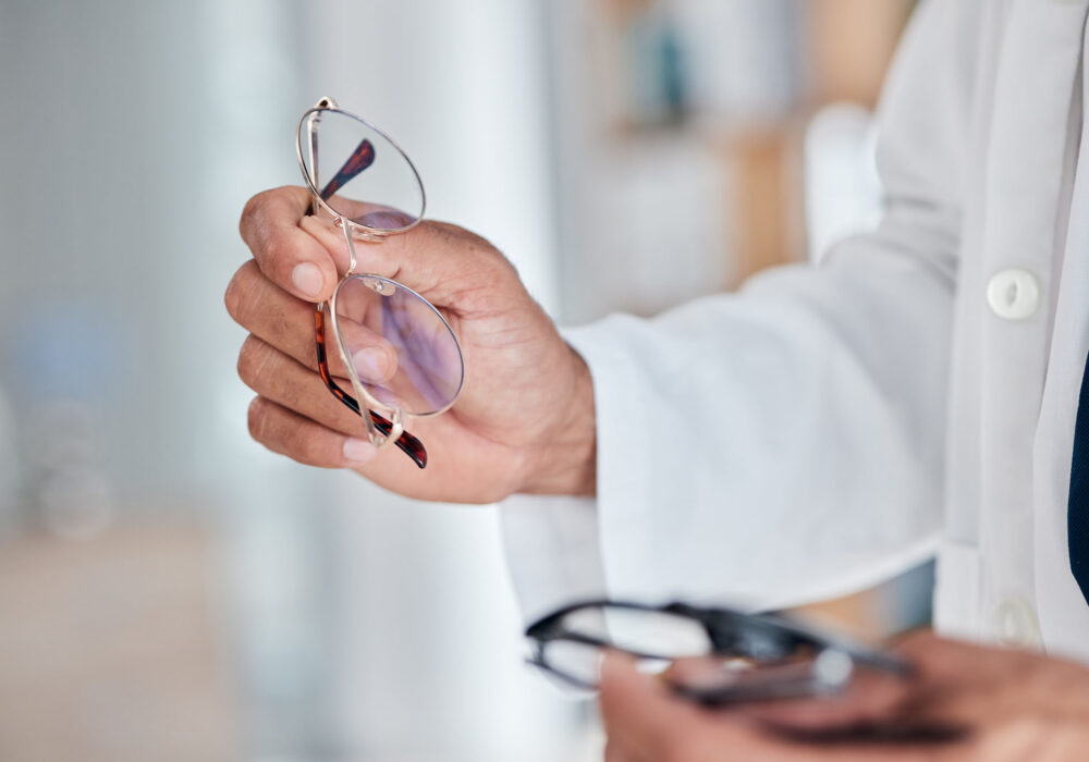 Hands, glasses and optometry with an optician in a clinic to rec Hands, glasses and optometry with an optician in a clinic to recommend prescription frame lenses fo.