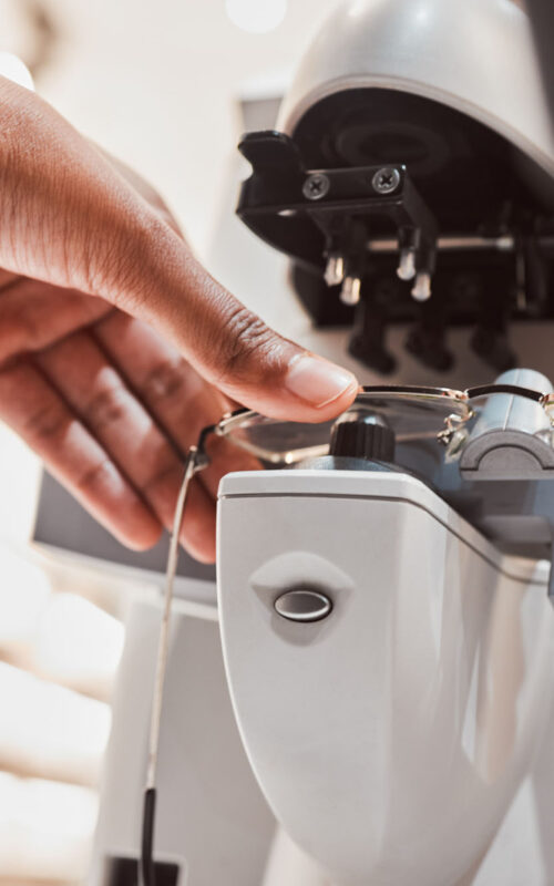 Hands, glasses and vision with an optometrist working in a clini Hands, glasses and vision with an optometrist working in a clinic to configure frame prescription l.